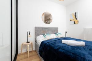 Кровать или кровати в номере Atrium Promenada Apartments Gocław by Renters