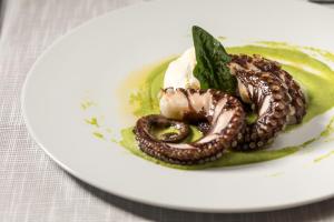 a plate of food on a white plate at Living Place Hotel in Villanova
