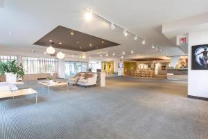 a large lobby with couches and tables in a building at Living Place Hotel in Villanova +37 photos