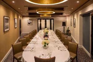 a long dining room with a long table and chairs at Crowne Plaza Harrogate by IHG in Harrogate