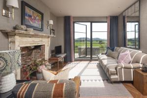 a living room with a couch and a fireplace at Decoy Farm House in Somerton