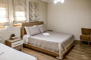 a bedroom with a bed with a laptop on it at Vila Leo Lux in Korçë