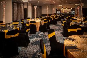 a conference room with tables and chairs and tablesktop at Crowne Plaza Harrogate by IHG in Harrogate +188 photos