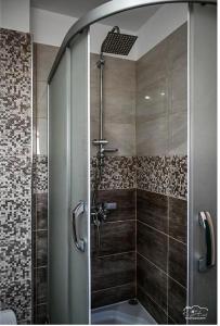 a shower with a glass door in a bathroom at Vila Leo Lux in Korçë +70 photos