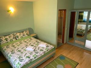 a small bedroom with a bed and a mirror at Vila Andra in Azuga +11 photos