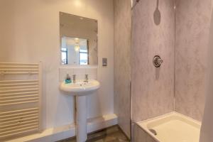 a bathroom with a sink and a shower at Lever St Central in Manchester