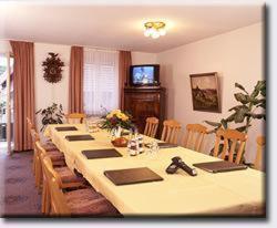 a large dining room with a long table with chairs at TIPTOP Hotel Garni Pfauen in Endingen