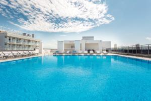 a large swimming pool on the roof of a hotel at CORUDO Family Resort&Spa in Vityazevo