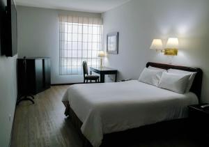 Postel nebo postele na pokoji v ubytování Hotel Internacional La Triada