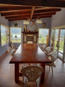 a dining room with a large wooden table and chairs at Lo de Ely in Tafí del Valle