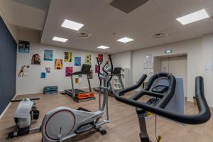 a gym with two treadmills and two exercise bikes at Villages Clubs du Soleil - MARSEILLE in Marseille