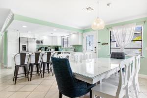 a dining room and kitchen with a table and chairs at LaRaya Retreat in Anna Maria