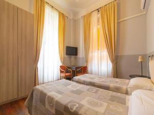 Postel nebo postele na pokoji v ubytování Hotel Portofino