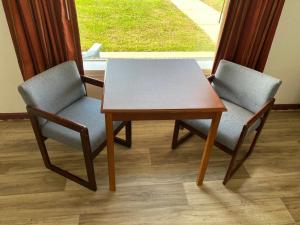 two chairs and a table in front of a window at Royal Inn in Albany