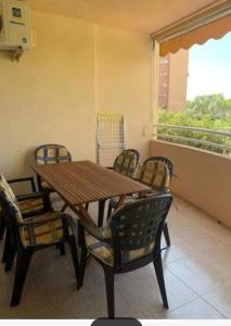 a wooden table and chairs on a balcony at Dehesa de Campoamor in Orihuela