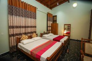 Postel nebo postele na pokoji v ubytování Nirosha Guest House + 37 fotografií