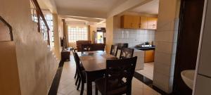 a kitchen and dining room with a table and chairs at Desa Homes in Voi