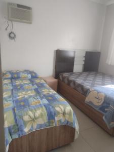 a bedroom with two beds and a air conditioner at Tranquilidade e lazer in Piratuba