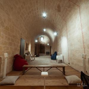 a room with a table and chairs in a building at Piano Piano - Rooms in Matera