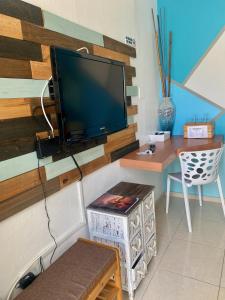 a living room with a flat screen tv on a wall at Aqua Marina Beach Club in Rincon