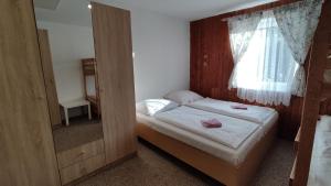 Postel nebo postele na pokoji v ubytování Penzion Na Sluníčku