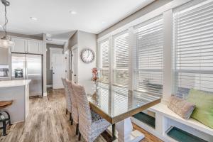 a dining room with a table and chairs and a window at Driftwood Pearl in Lincoln City