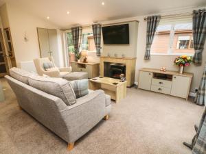 a living room with two couches and a fireplace at The Warren in Skipton