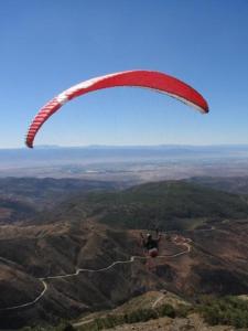 a person flying a parachute in the sky at Hotel la belle vue 2100m in Taroudant