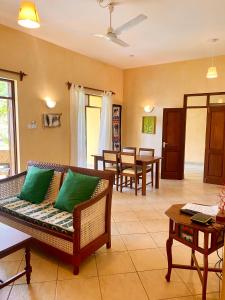 a living room with a couch and a table at Flametree Beach Homes in Diani Beach