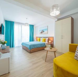a bedroom with a bed and a table and a couch at Passerella Apartments in Bar