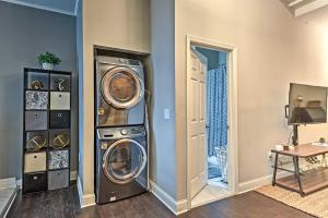 a laundry room with a washer and dryer next to a door at Chic Baltimore Apartment 2 Mi to Downtown! in Baltimore