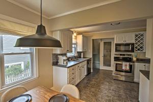 a kitchen with a dining table and aendant light at Ideal Green Bay Home Less Than 3 Mi to Lambeau Field! in Green Bay