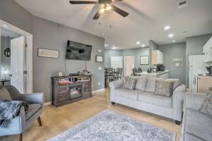 a living room with a couch and a tv and a table at Branson Resort-Style Retreat 4 Mi to Strip in Branson