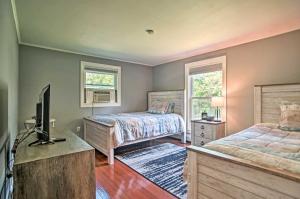 a bedroom with two beds and a flat screen tv at Family-Friendly Tisbury Escape - Walk to Town in Vineyard Haven