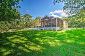 a house in a field with a green yard at Family-Friendly Tisbury Escape - Walk to Town in Vineyard Haven