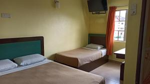Postel nebo postele na pokoji v ubytování Ria Cameron Hotel