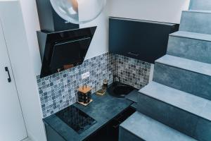 a small bathroom with a sink and a stove at La Villa Monroe - Un écrin de volupté épicée in Le Vézier