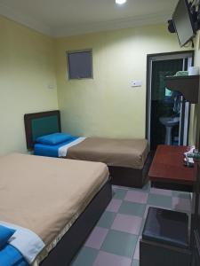 Postel nebo postele na pokoji v ubytování Ria Cameron Hotel