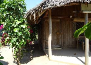 a small hut with a straw roof at Jabar Lodge in Zanzibar City