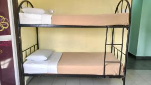 Postel nebo postele na pokoji v ubytování Ria Cameron Hotel