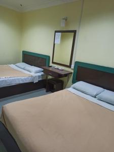 Postel nebo postele na pokoji v ubytování Ria Cameron Hotel