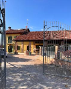 a gate in front of a building with a house at La Casa delle Favole in Fossano