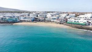 an aerial view of a beach with white buildings at Blancazul Tegala in Playa Blanca