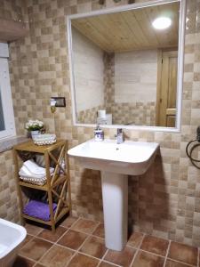 a bathroom with a sink and a mirror at VENTA DE LA CASA NOGUERA in Riópar