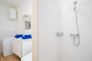 a white bathroom with a shower and a toilet at Blancazul Tegala in Playa Blanca +17 photos