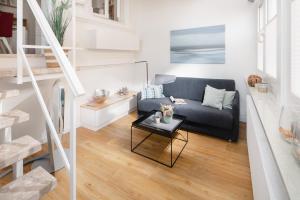 a living room with a couch and a table at Fewo Grete in Norderney