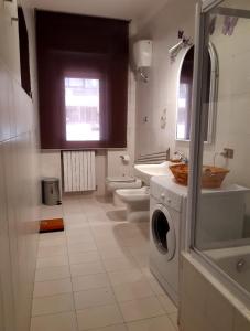 a bathroom with a washing machine and a sink at Casa Trastevere in Foggia
