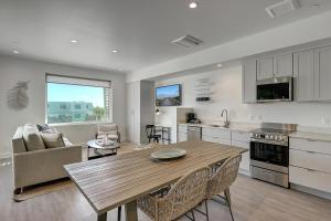 cocina y sala de estar con mesa de madera y sillas en Lively Beach en Corpus Christi