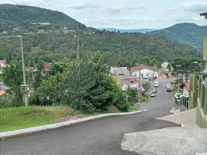 a street in a small town with a mountain at Espaço da Mélia in Gramado