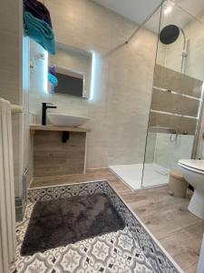 a bathroom with a sink and a toilet and a shower at Hôtel Le Picardy in Saint-Dizier